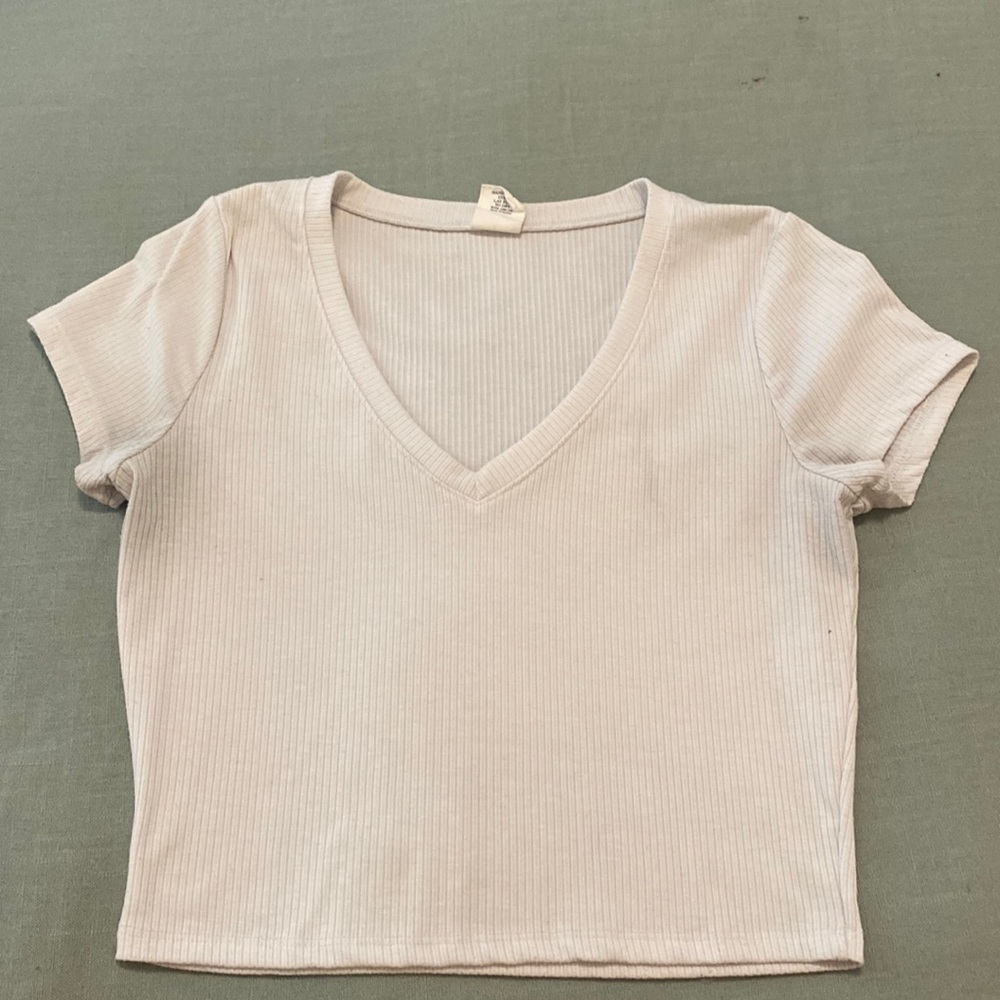Cropped, tight, white shirt.